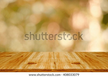 Wood table top on bokeh abstract green background - can be used for montage or display your products
