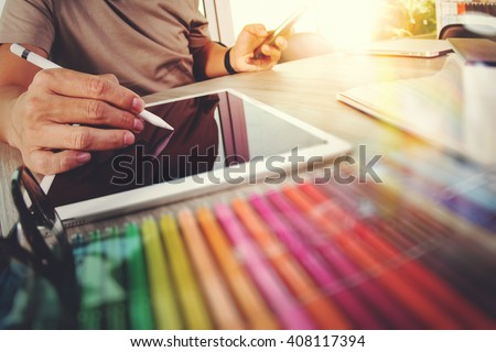Website designer working digital tablet and computer laptop with smart phone and graphics design diagram, work from home as concept Royalty-Free Stock Photo #408117394