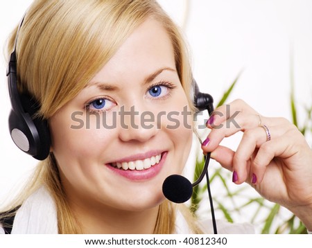 closeup of smiling blond woman with headphone in office