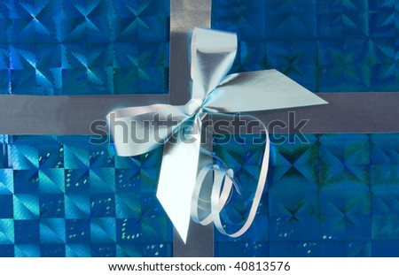 silver holiday bow on blue background