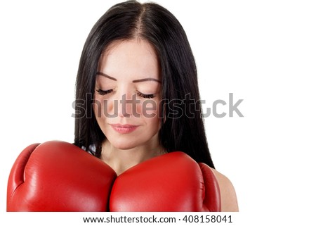 Portrait of a beautiful young brunette woman with red boxing gloves and closed eyes. No retouch. Isolated on white background in studio