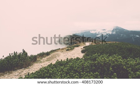Tatra mountains in Slovakia covered with clouds. autumn colors. - vintage film retro effect