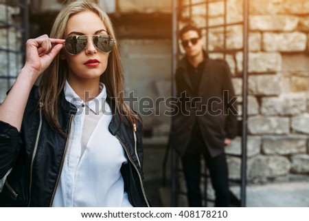young beautiful couple posing on the background of an old building