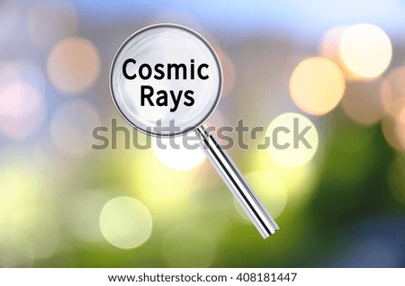 Magnifying lens over background with text Cosmic Rays, with the blurred lights visible in the background. 3d Rendering.