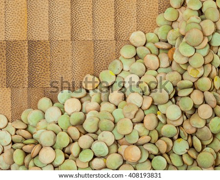 Natural organic green lentils on cork background