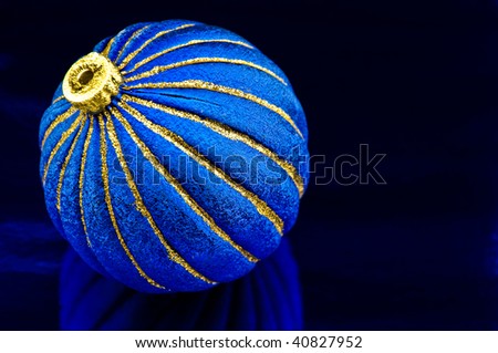 Bright  blue sphere for a christmas tree on a blue background
