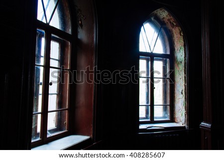 Light through the old wooden windows in an abandoned building dark gloomy