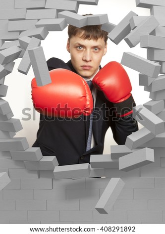 Businessman in red boxing gloves and brick wall