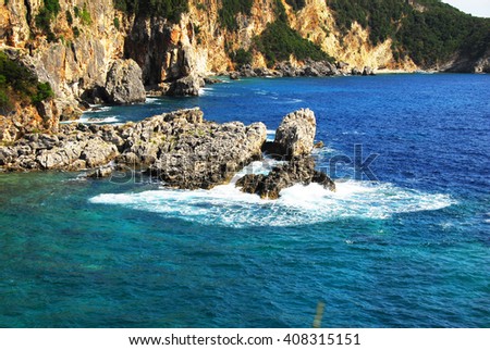 rocks surrounded by clear blue Ionian sea in Greece