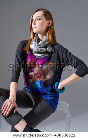 fashion model in modern dress with scarf sitting cube 