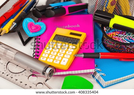 Back to school - blackboard with pencil-box and school equipment on table
