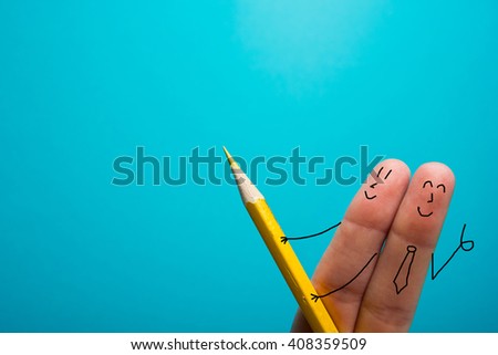 Funny finger holding pencil and smiling. Ad concept, copy space for text.