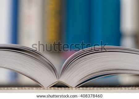 Detail view of open book in library. Shallow depth of field. Horizontal shot.