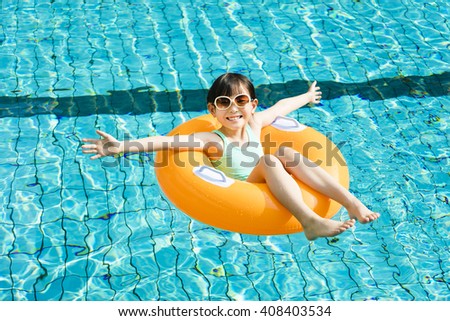 happy little girl having fun  in swimming pool Royalty-Free Stock Photo #408403534