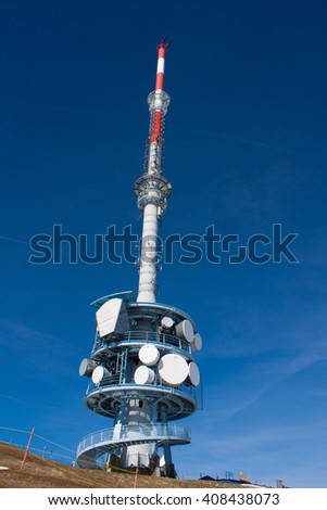 Broadcast / Radio Mast on the top of the mountain Rigi with a mountain rail and a blue background