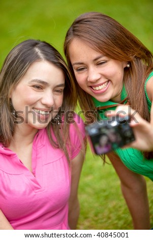 Girls outdoors taking a picture of themselves