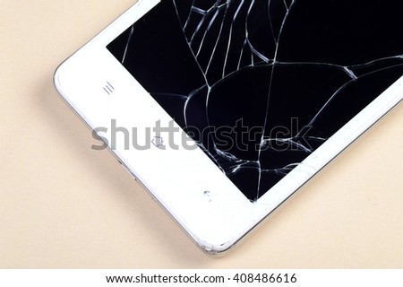 Smart Phone with broken screen on cream background