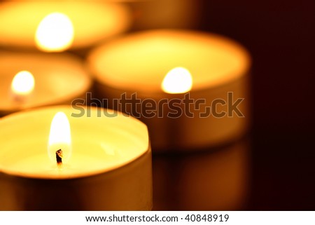Burning warm candles close-up on a table