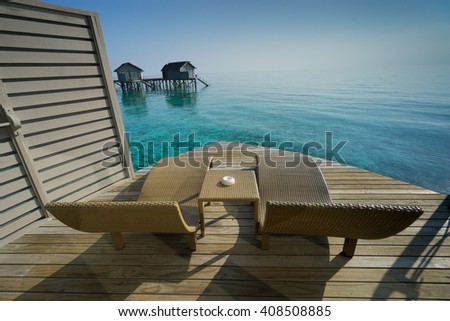 Two deck chairs on a sea view balcony at Maldives