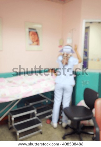 background blur of  nurses are to patients by providing saline intravenously in a hospital.