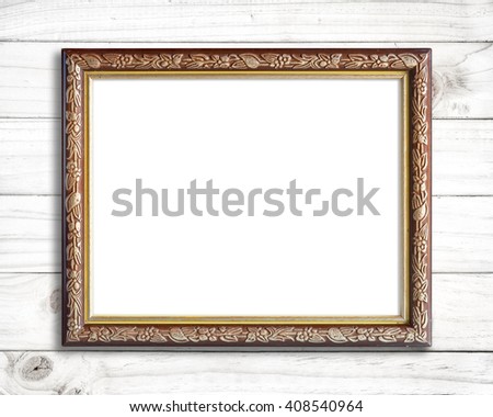 Old picture frame on white wood wall.