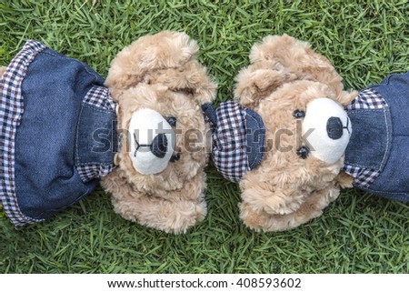 Couple teddy bears rest on lawn, two teddy bears relax in garden, love and friendship concept
