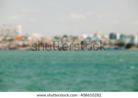 Abstract blur city beside the sea for background