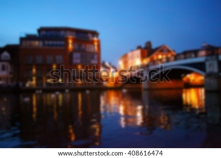 The out of focus night light of river scene among riverside building represent the night atmosphere concept related idea.