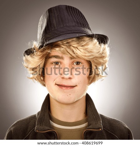 trendy vintage blonde boy with hat portrait on grey background