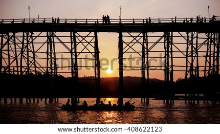 Silhouetted bridge at sunset in Sangkla,Thailand
