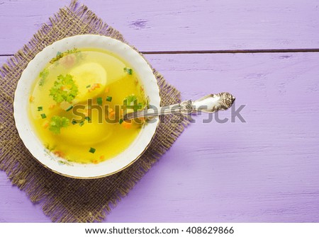 broth with vegetables in plate on wooden table .Rustic style.
 Top view. Free space for text.