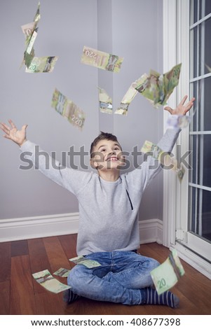 Little boy throwing money in the air; kids and learning value of money