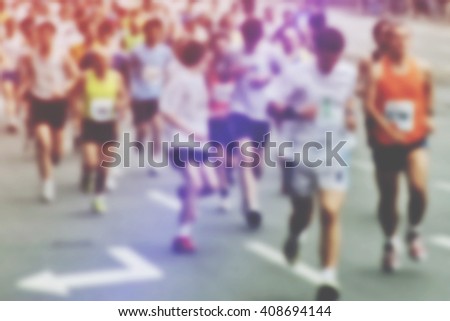 Blur image of people running a marathon race through city, defocussed photo of sport event, unrecognizable man and women racing through urban environment, retro toned