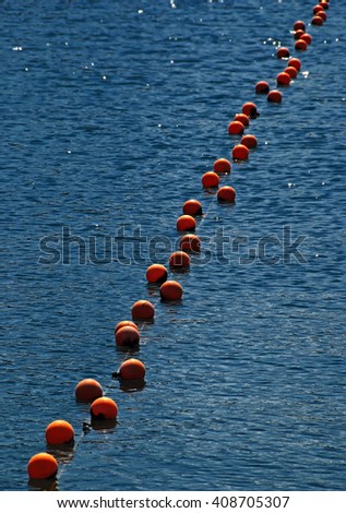 Red buoys on blue water suface on lake Sevan, Armenia
