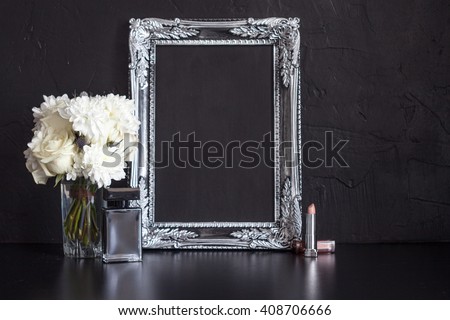 Vintage photo frame and flowers on a black textured background. Place for your text