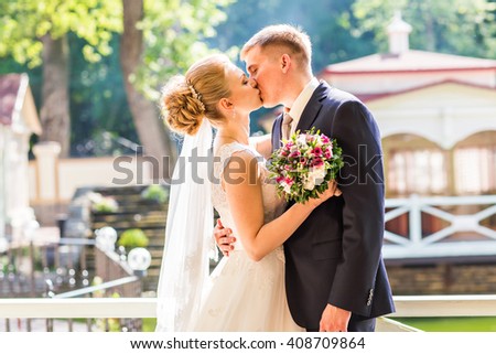 Kiss the bride and groom Royalty-Free Stock Photo #408709864