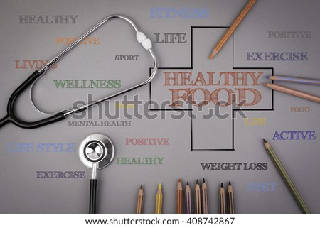 Healthy Food word cloud, health cross concept. Colored pencils and a stethoscope on the table
