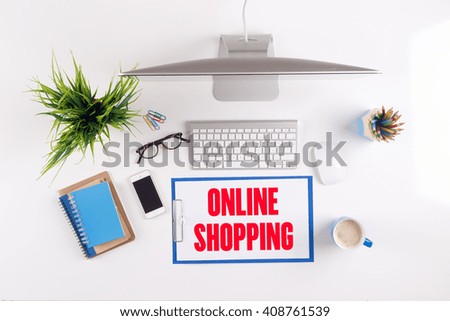 Office desk with ONLINE SHOPPING paperwork and other objects around, top view