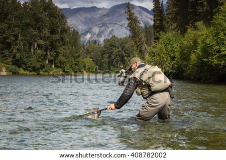 Fly fishing in the pristine wilderness of Canada  Royalty-Free Stock Photo #408782002