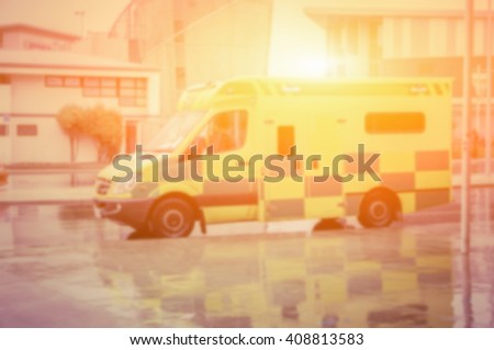 blurred background of An ambulance speeding through the streets.in vintage color effect.