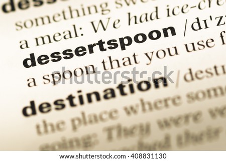 Close up of old English dictionary page with word dessertspoon