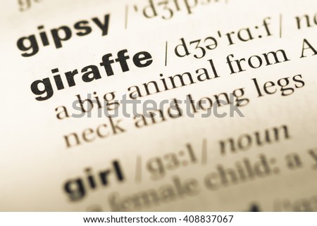 Close up of old English dictionary page with word giraffe