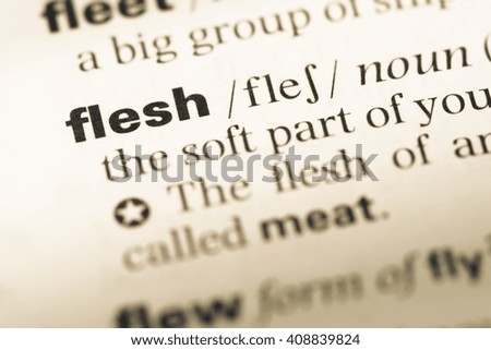 Close up of old English dictionary page with word flesh