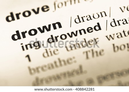 Close up of old English dictionary page with word drown