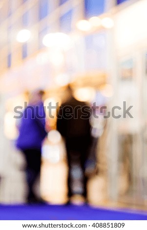 Blur of two men standing and talking; blurred 100%