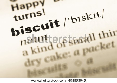 Close up of old English dictionary page with word biscuit