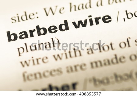Close up of old English dictionary page with word barbed wire