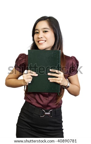 Beautiful college student wearing brown shirt holding book in her hand. She looks happy and intelligent