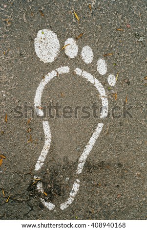 Foot shape painting on a paved road