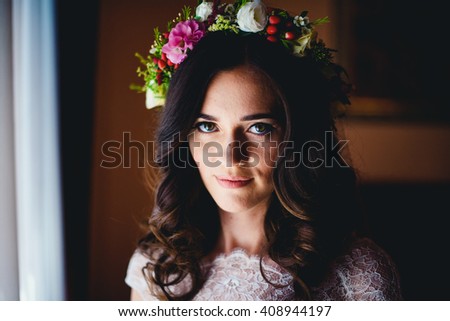 charming dark-haired bride looks at photographer